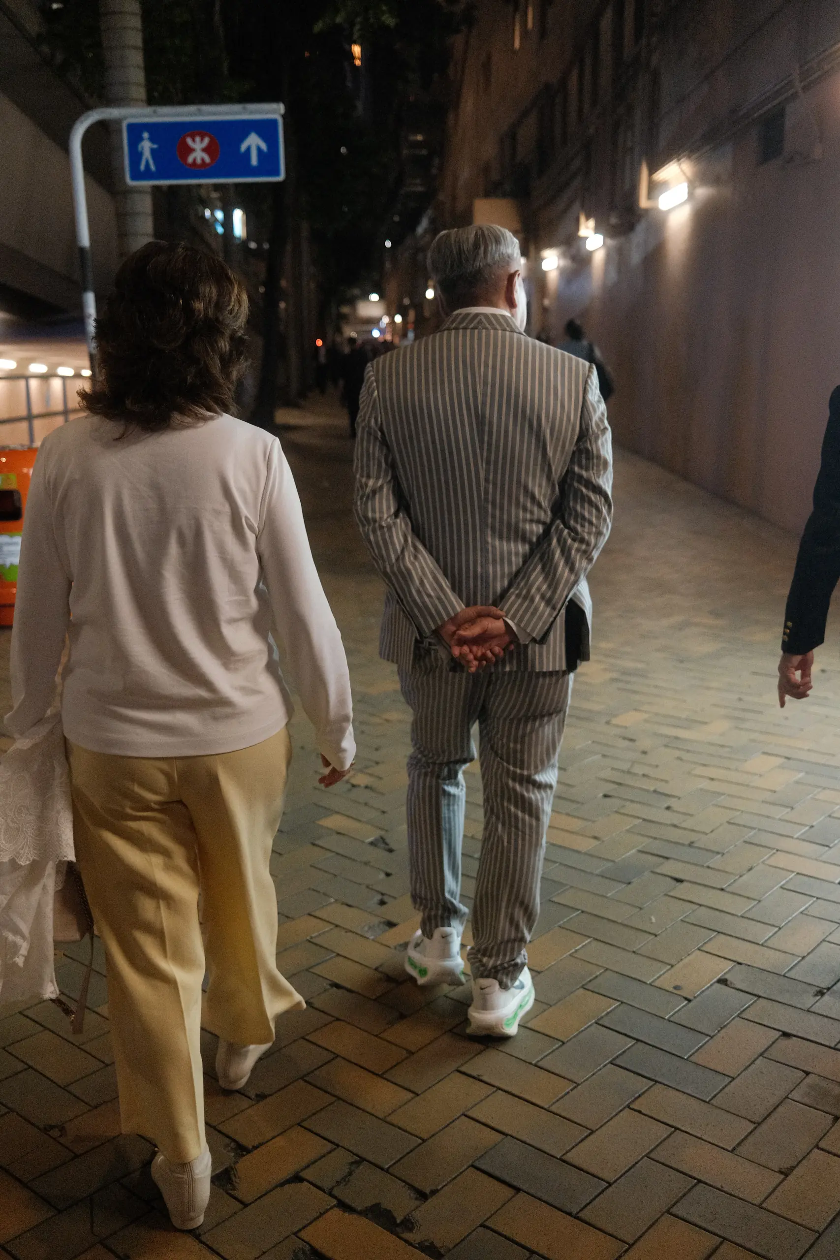 A couple walking home through Happy Valley after the races