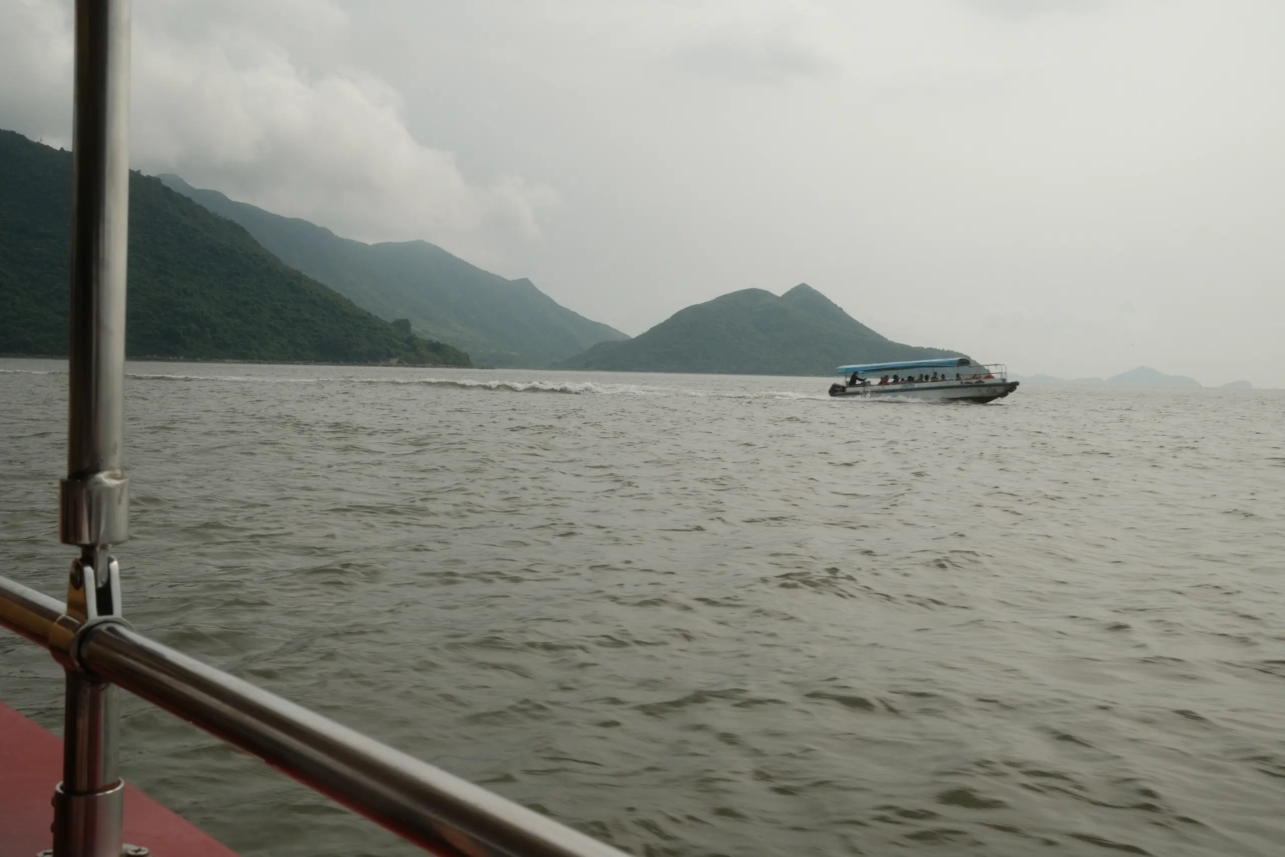 A boat crossing the bay off Tai O under grey skies