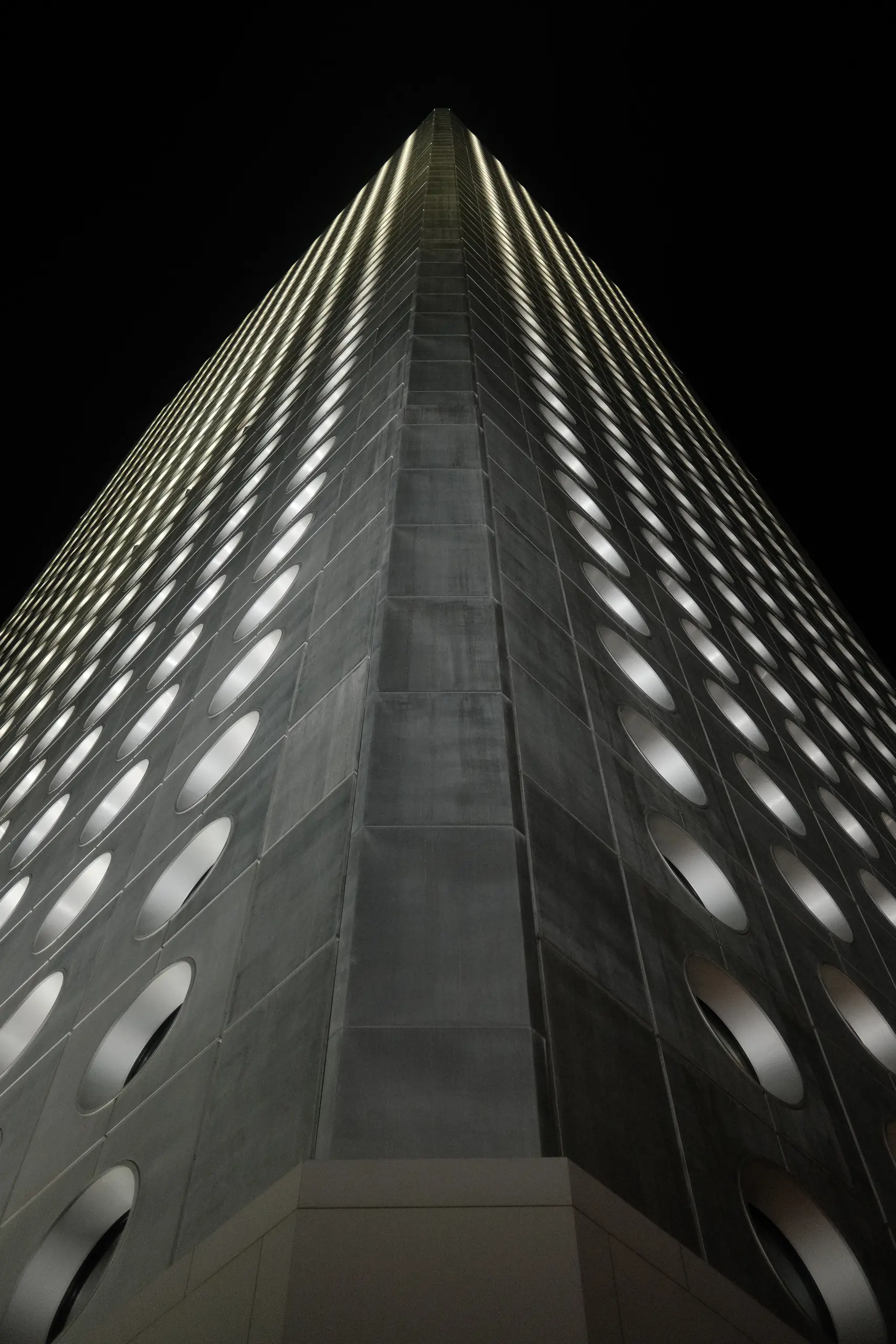 The lit facade of M+ at night