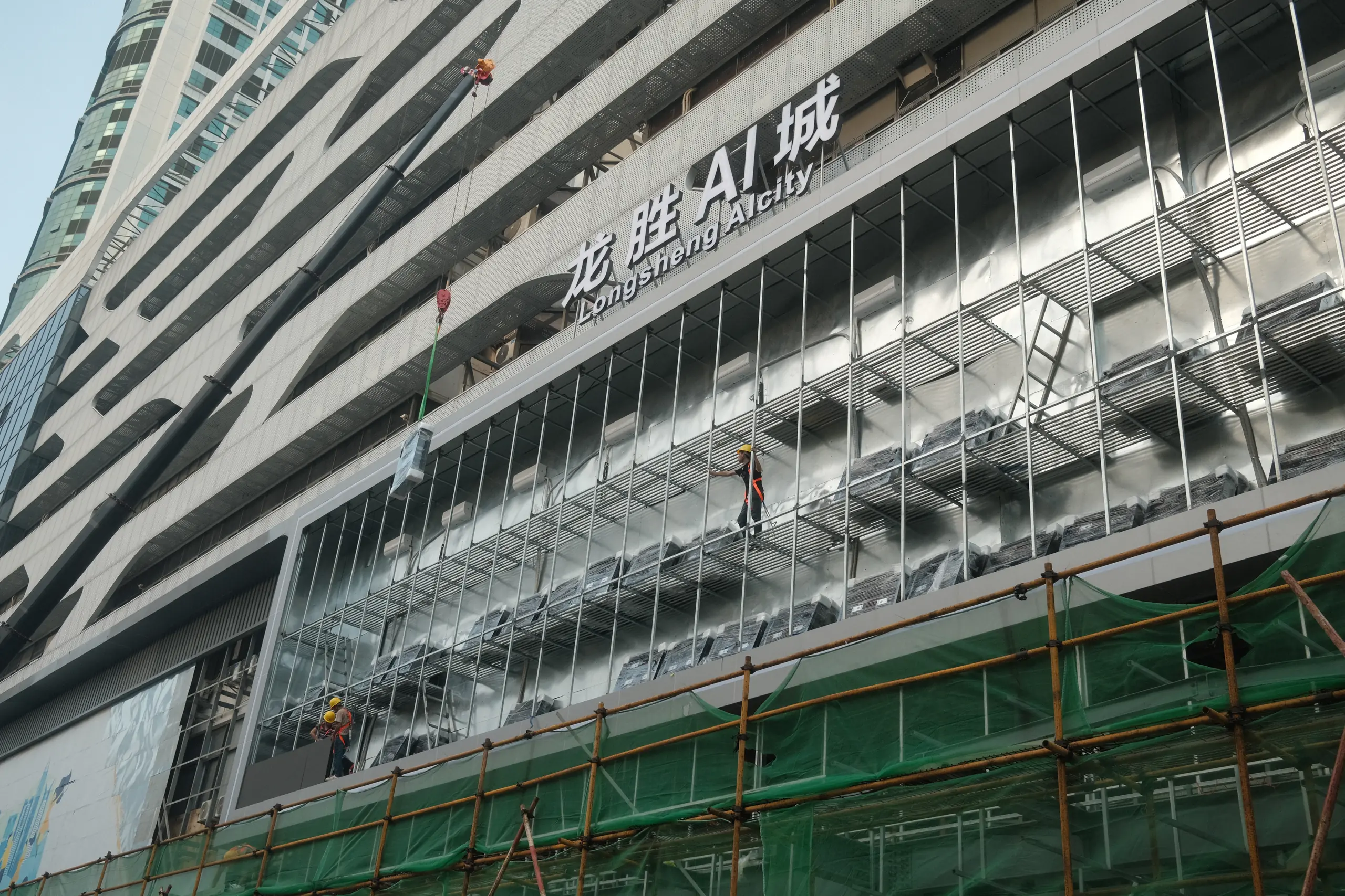 A new building wrapped in green scaffolding netting