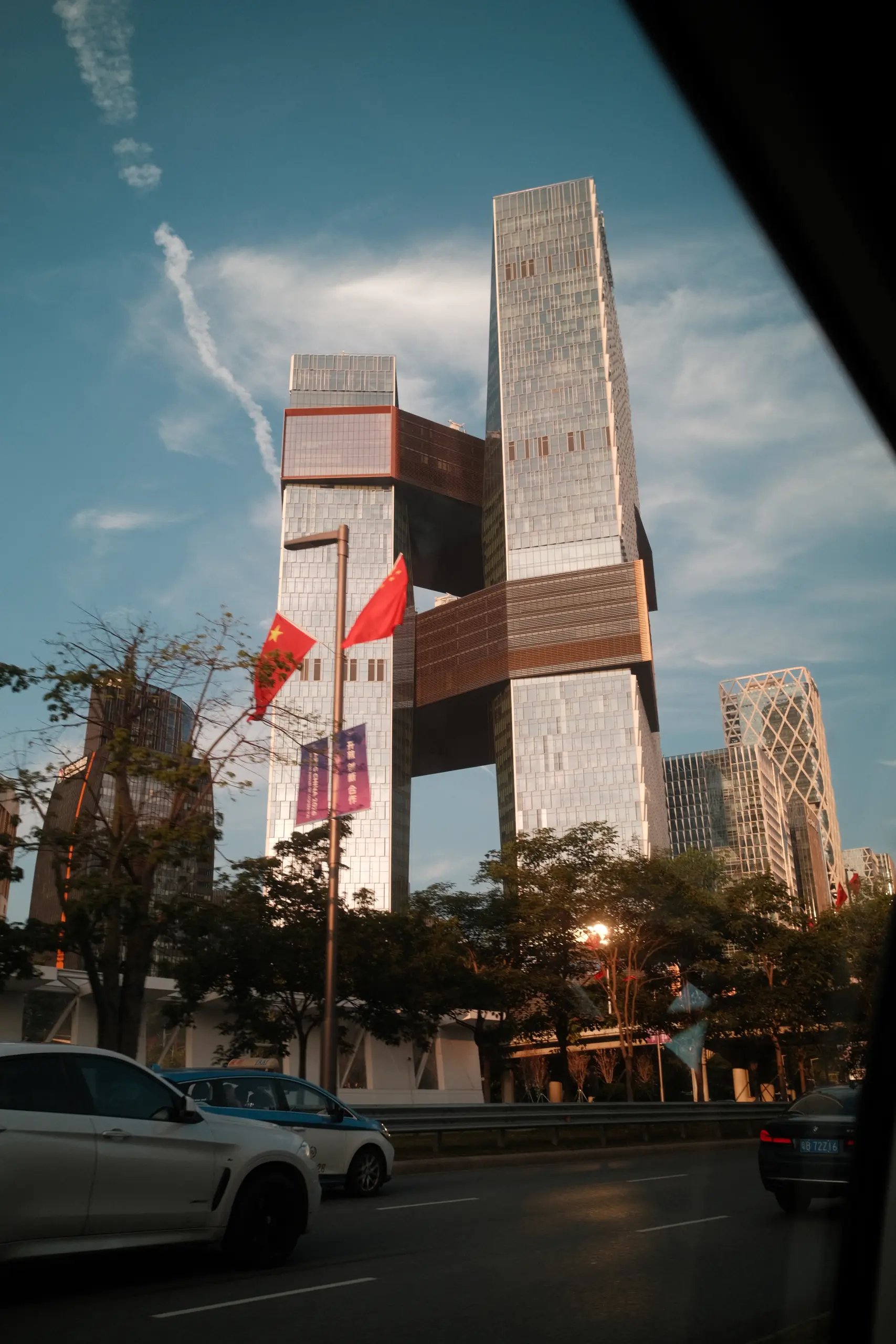 Office towers and red flags against the sky in Futian