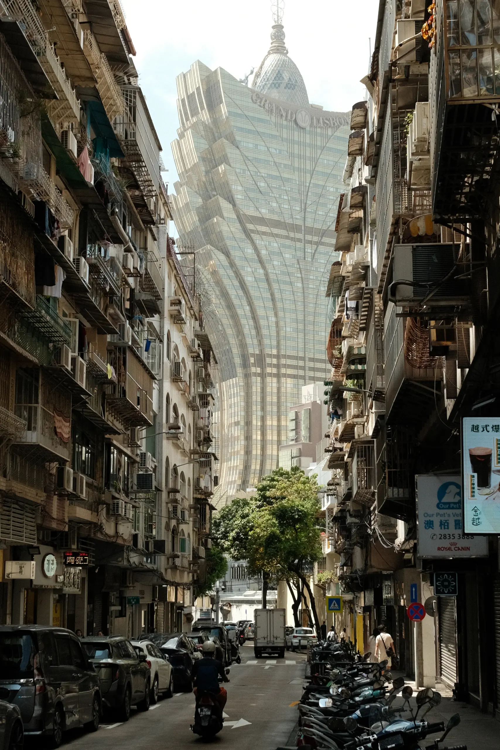 A narrow Macau street with the Grand Lisboa at the end