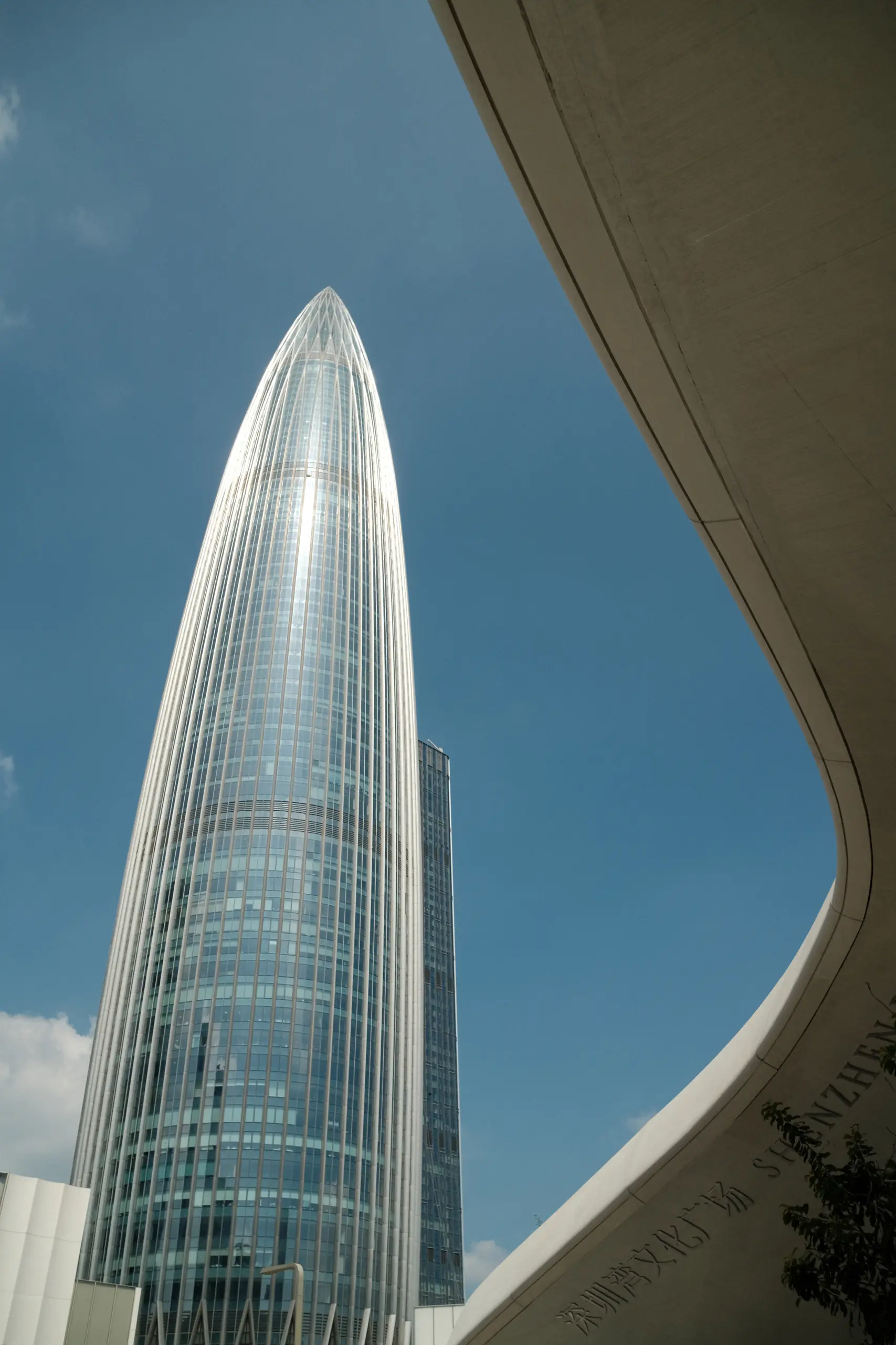 The Ping An tower framed by a white arch of the museum
