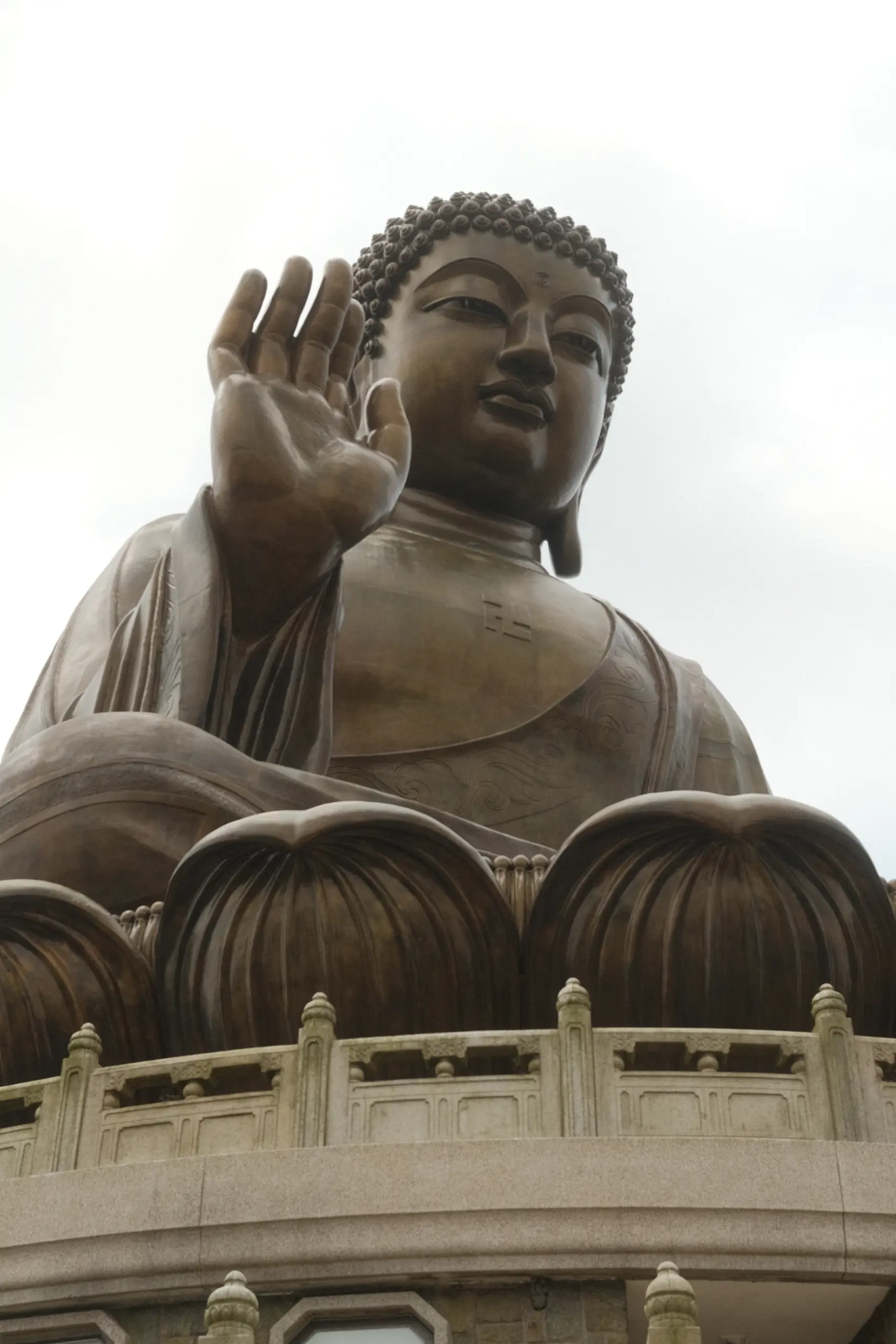 The Big Buddha seen from below against a white sky