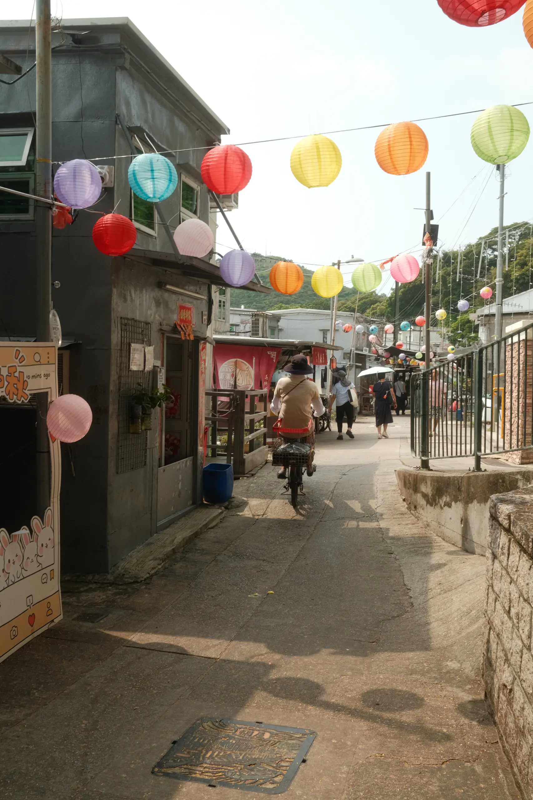 Paper lanterns strung over a narrow lane in Tai O