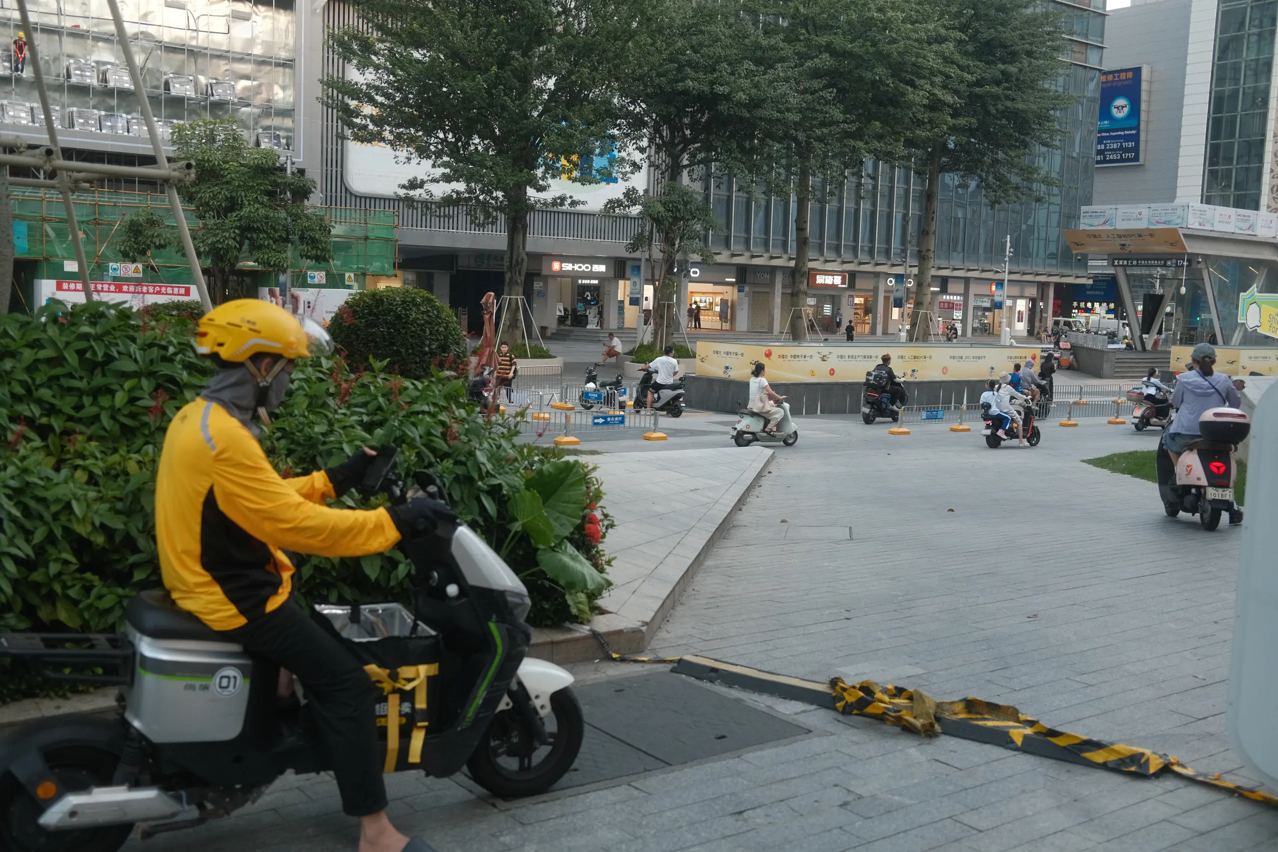 A delivery courier on an electric scooter