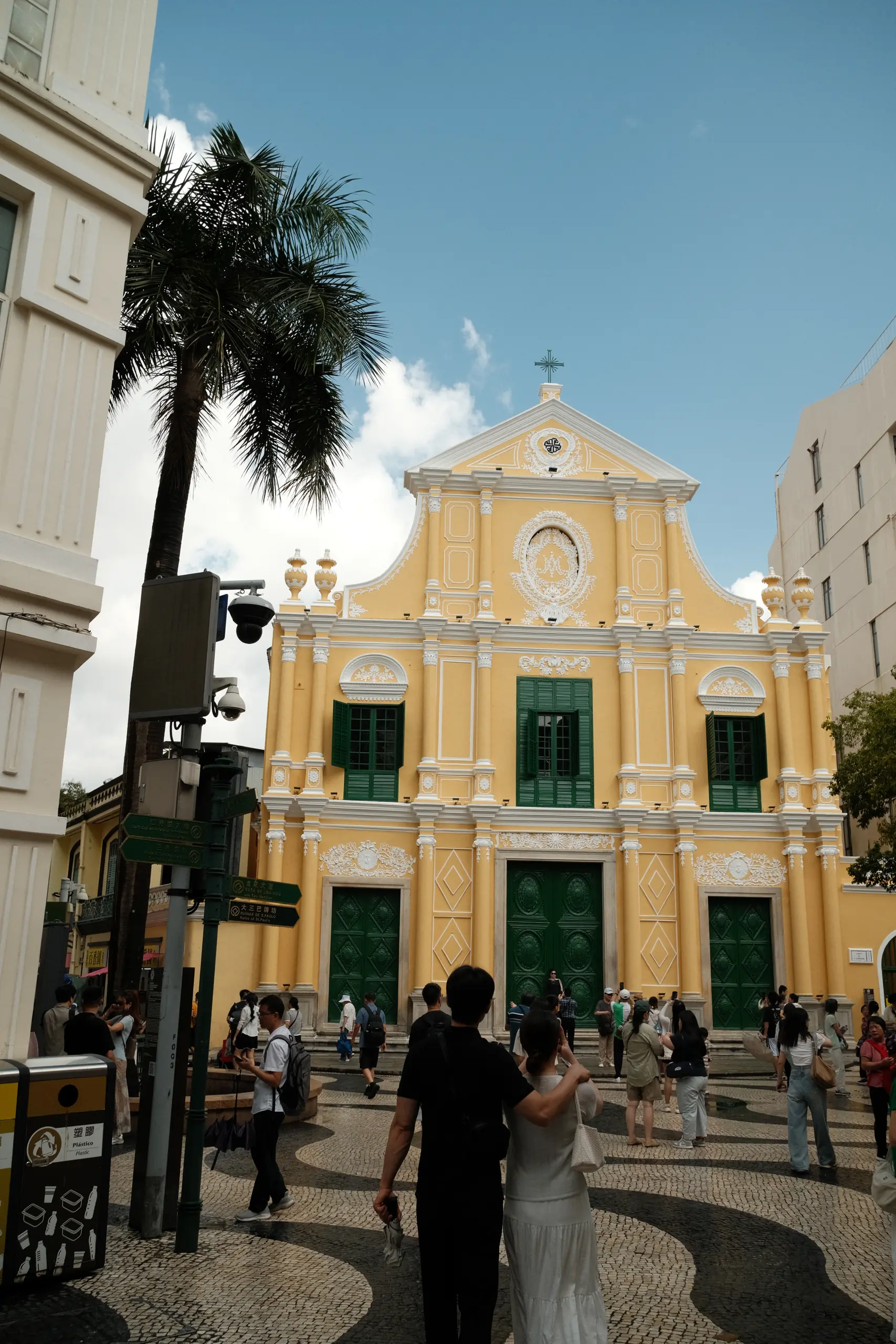 The yellow facade of St. Dominic's Church with a palm tree
