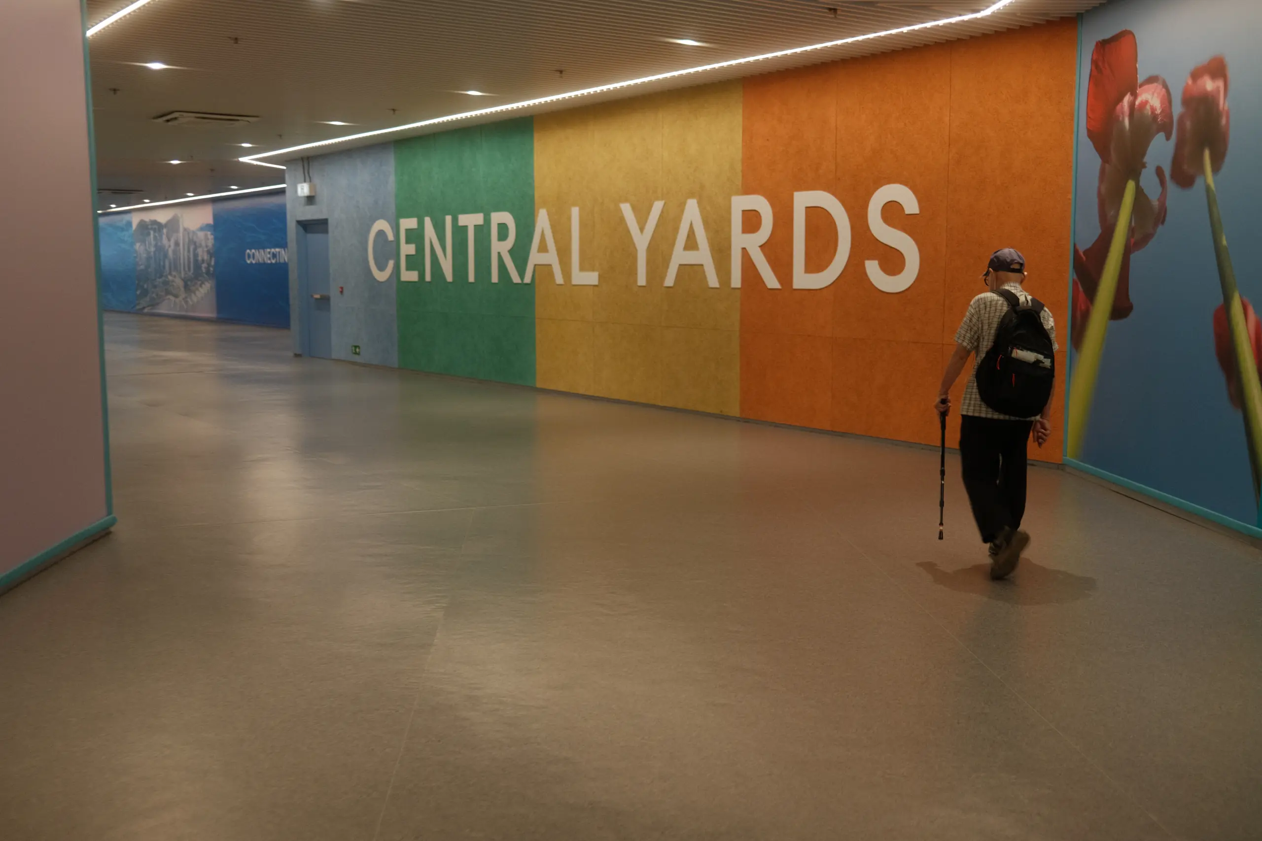 A colourful wall reading Central Yards in an air-conditioned passage