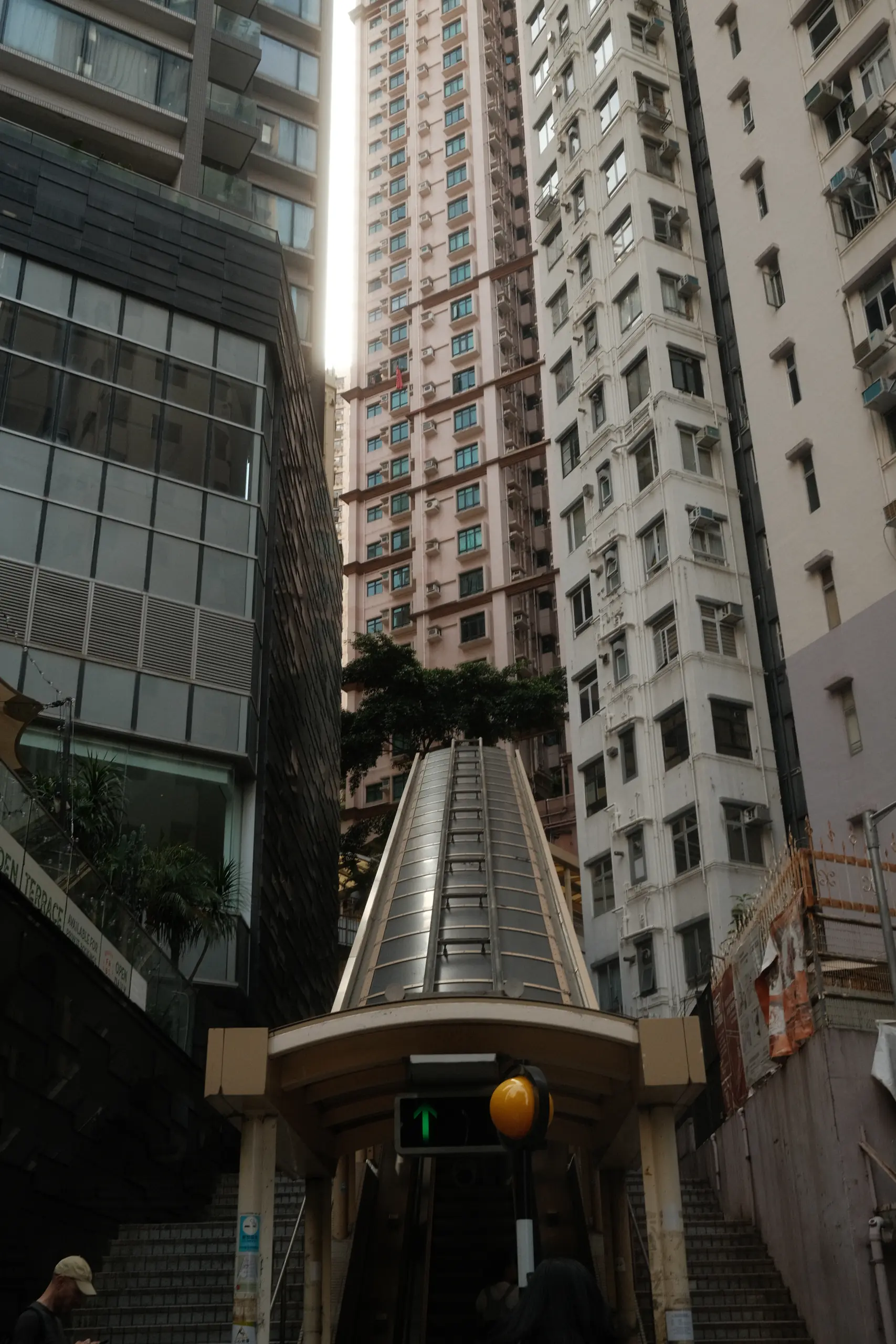 Looking up the Mid-Levels escalator between apartment blocks