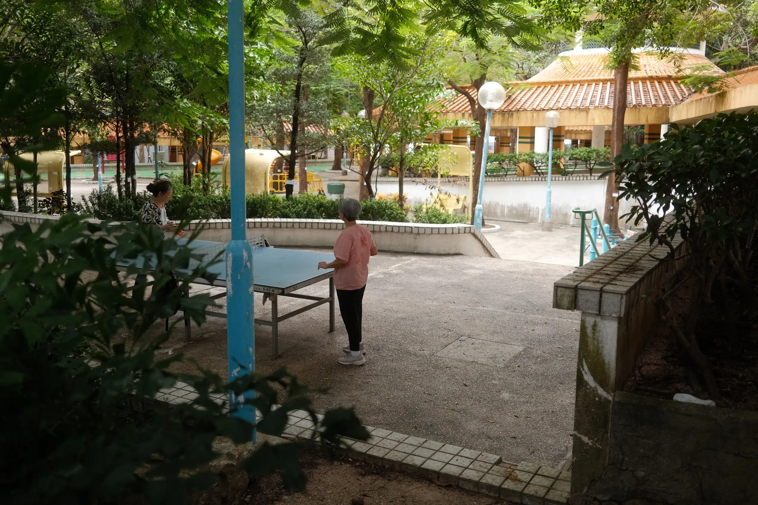A ping-pong table in a park between housing blocks