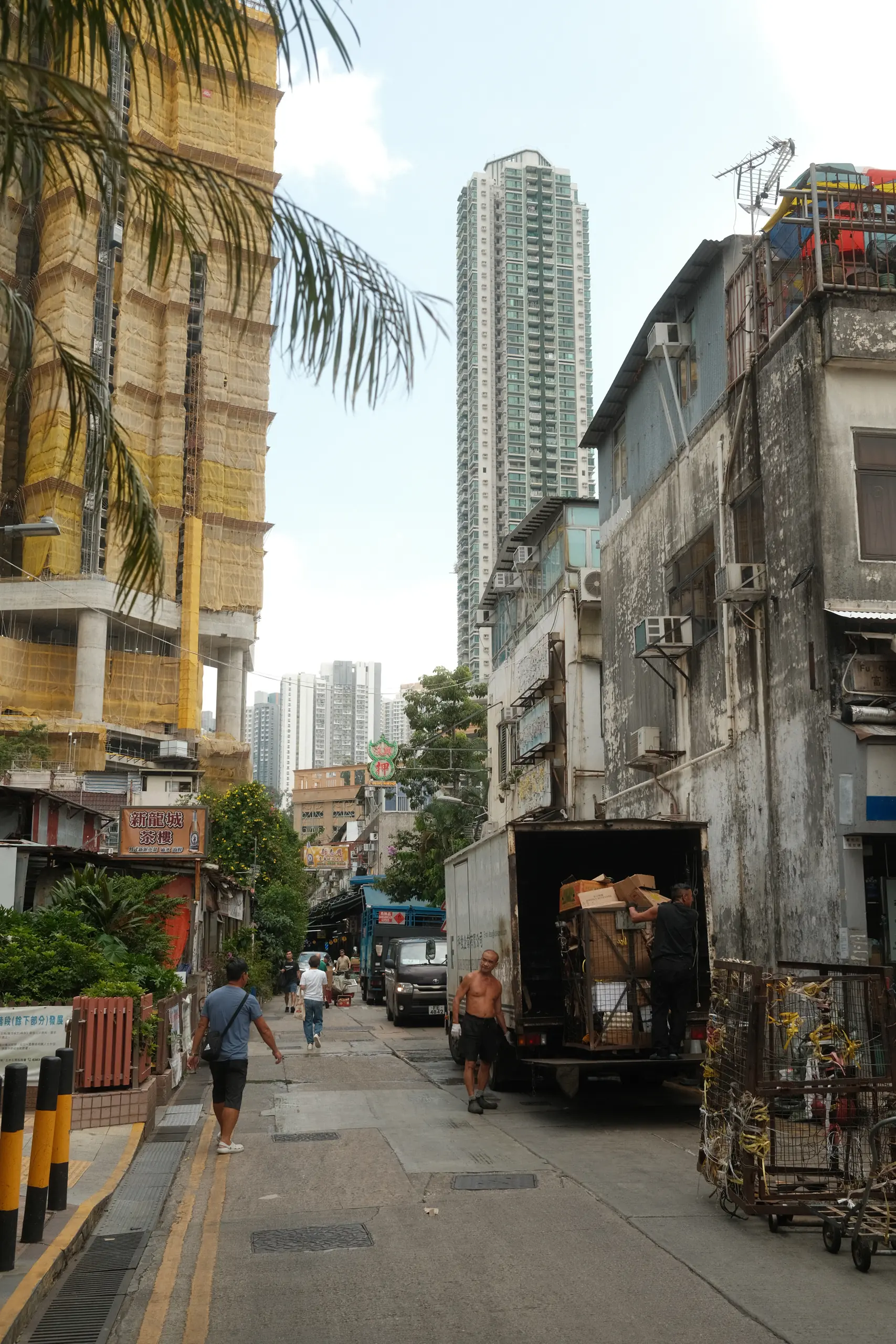 A delivery truck parked in a narrow Kowloon street