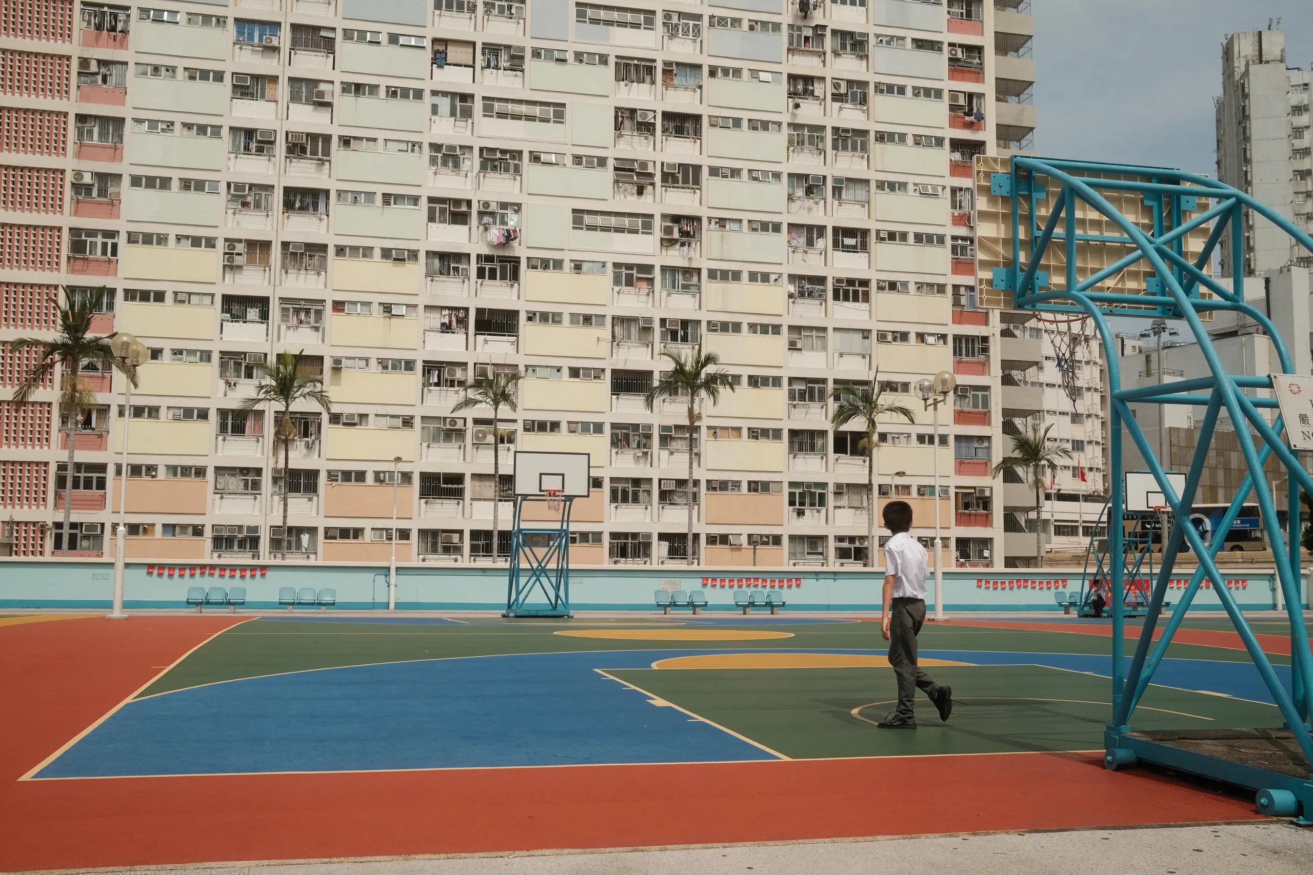 The basketball court at Choi Hung Estate with its pastel towers